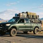 Custom truck loaded for a road trip with camping gear before hitting the open highway