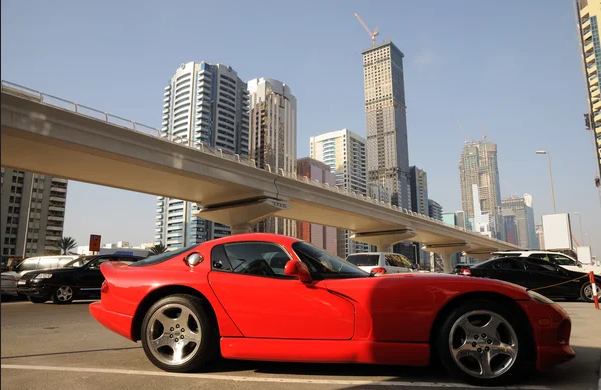 Sports car traveling on a modern roadway in Dubai