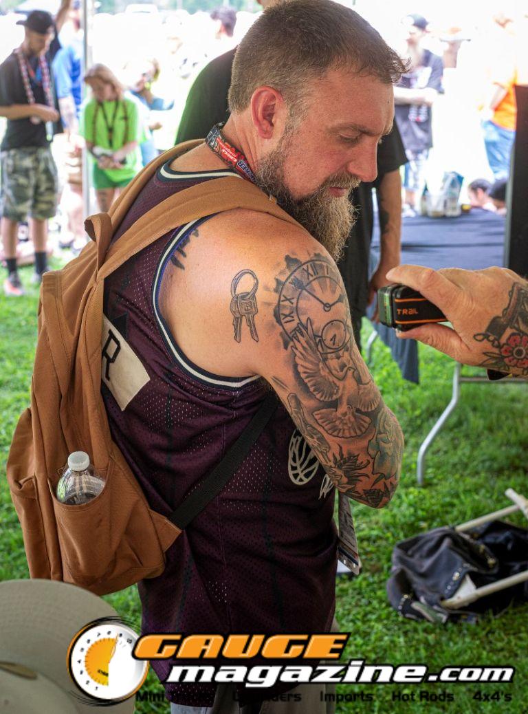Contestants showing tattoo artwork during the Slamology 2026 Tattoo Contest on the Orion Car Audio Stage