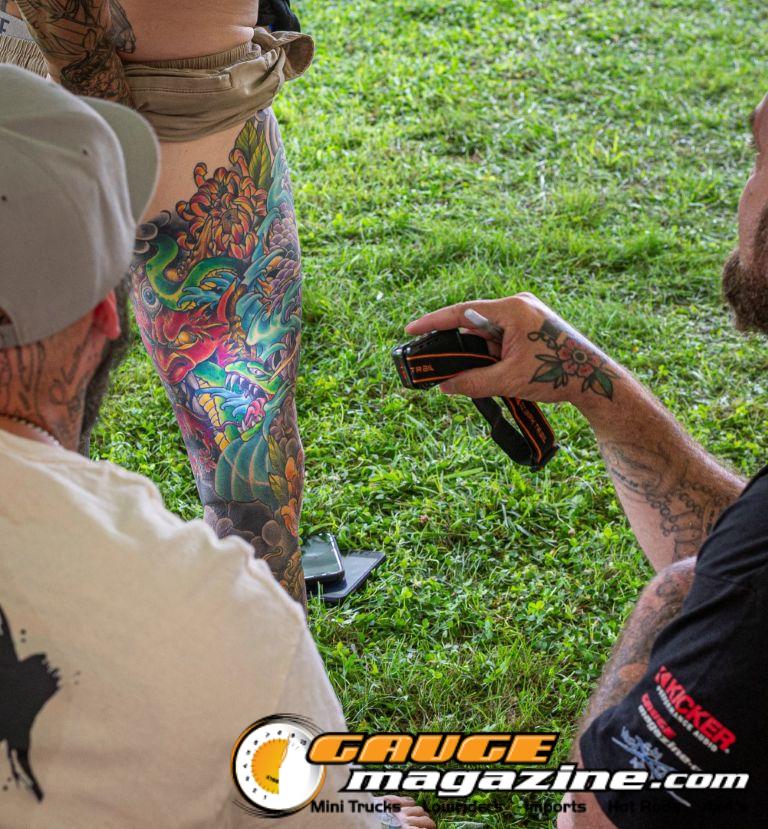 Contestants showing tattoo artwork during the Slamology 2026 Tattoo Contest on the Orion Car Audio Stage