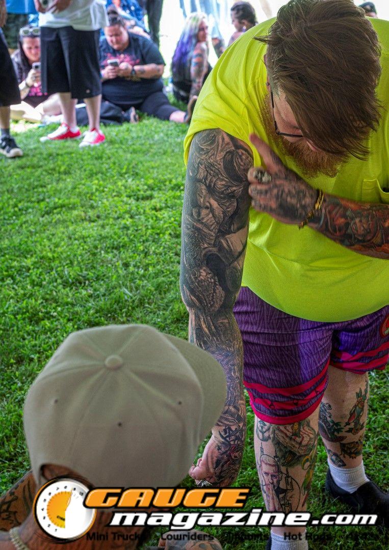 Contestants showing tattoo artwork during the Slamology 2026 Tattoo Contest on the Orion Car Audio Stage