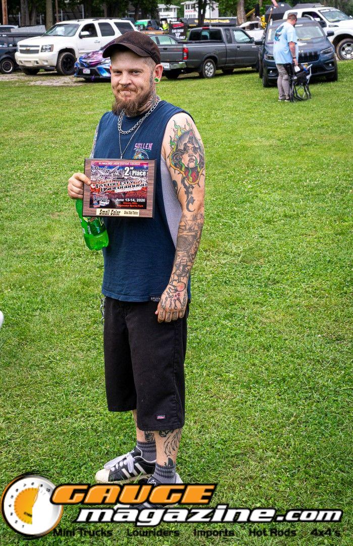Contestants showing tattoo artwork during the Slamology 2026 Tattoo Contest on the Orion Car Audio Stage