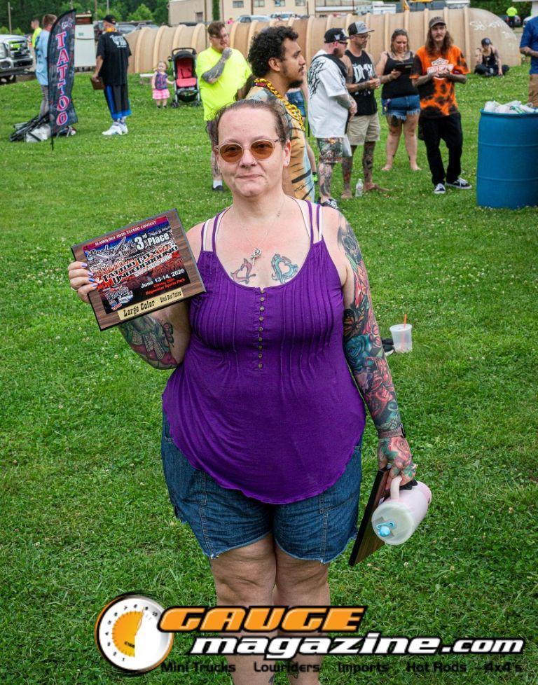 Contestants showing tattoo artwork during the Slamology 2026 Tattoo Contest on the Orion Car Audio Stage