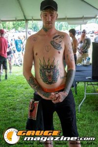 Contestants showing tattoo artwork during the Slamology 2026 Tattoo Contest on the Orion Car Audio Stage