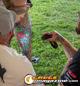 Contestants showing tattoo artwork during the Slamology 2026 Tattoo Contest on the Orion Car Audio Stage
