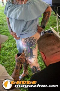 Contestants showing tattoo artwork during the Slamology 2026 Tattoo Contest on the Orion Car Audio Stage