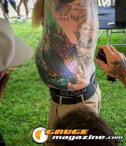 Contestants showing tattoo artwork during the Slamology 2026 Tattoo Contest on the Orion Car Audio Stage