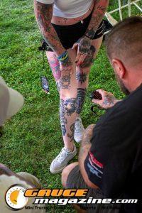 Contestants showing tattoo artwork during the Slamology 2026 Tattoo Contest on the Orion Car Audio Stage