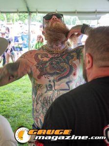 Contestants showing tattoo artwork during the Slamology 2026 Tattoo Contest on the Orion Car Audio Stage