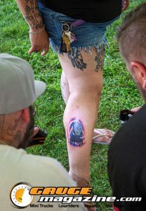 Contestants showing tattoo artwork during the Slamology 2026 Tattoo Contest on the Orion Car Audio Stage