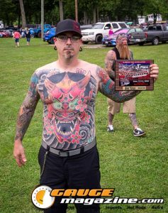 Contestants showing tattoo artwork during the Slamology 2026 Tattoo Contest on the Orion Car Audio Stage